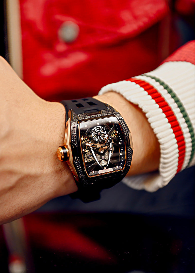 Luxury watch on a wrist with a red and white striped sleeve